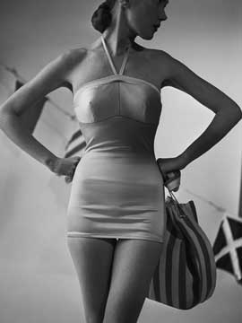 A Cole of California Swimsuit from 1950, made of pink nylon satin, photo courtesy of Corbis/Genevieve Naylor.