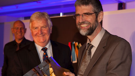 Philip Gross collects the 2010 Wales Book of the Year award from Minister for Heritage Alun Ffred Jones © Emyr Young / Academi