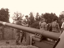 WWII soliders next to heavy guns
