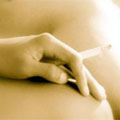 A hand holding a cigarette