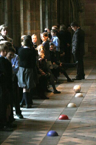Pancake race around the cloisters of Worcester cathedral involving choristers and clergy.  They raised money for the charity WaterAid.