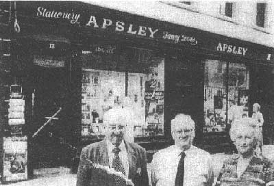 Llewellyn, George and Betty in front of the newsagents.