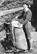 Image of a member of the Women's Land Army weighing corn