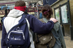 Teenagers with their arms around each other.