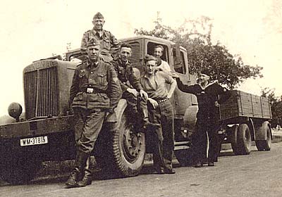 Picture of Tommy at the wheel of one of the German Trucks surrounded by 'friendly' Kriegsmarine guards