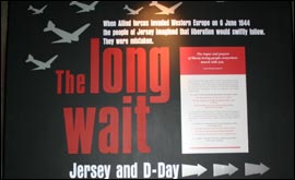 Sign showing aircraft  which reads: The Long Wait Jerey and D-Day