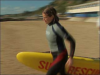 Victoria running with a surfboard