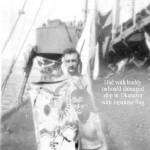 Charles Hladky (standing) with buddy holding Japanese banner.  Okinawa, Japan at end of war.