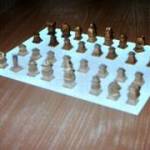 The PoW had hand carved these chess pieces.  The darker set were possibly stained with blackberries, to give them their hue.