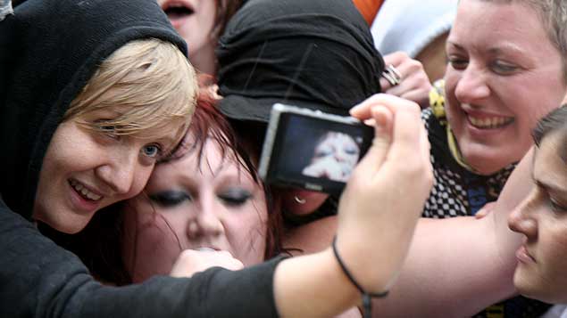 And she's over the fence and right in there with the fans who were already going wild before she got among them.