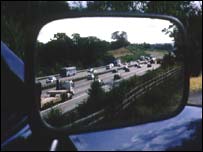 Traffic as seen in wing mirror