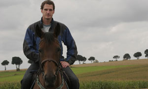 Dan Snow on horseback touring the battlefield of Le Cateau where in August 1914 his great grandfather commanded his division mounted on a horse
