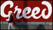 A woman walks past a billboard in Ireland. Reuters.