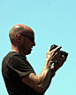 Man reviews photos on his camera