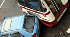 A collision between a bus and a car