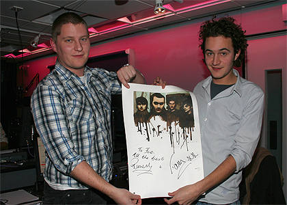 Russ and Tom hold up the artwork as won by Joe in the chatroom