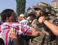 Photograph showing a clash between Nato soldier and an ethnic Albanian