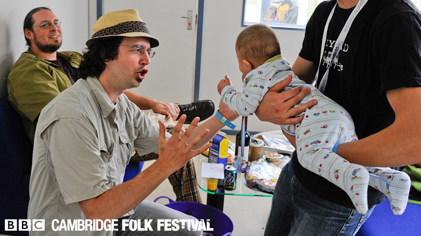 The members of Genticorum entertain a young fan with an a capella vocal performance.