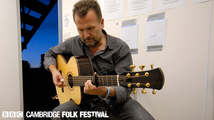 Martin Simpson warming up backstage at the Cambridge Folk Festival 2009.