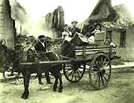 Image of a family mounted on a horse-drawn cart