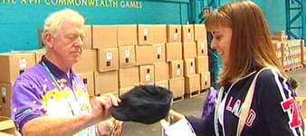 A volunteer is handed the controversial flat cap