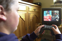 Image: boy playing with a computer game