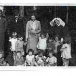 Children evacuated from the Cynthia Mosley Day Nursery arriving at Munstead House, Godalming, home of General Freyburg in September 1939. General Freyburg’s wife is third from left, wearing a grey suit and Edwin Pearson is holding her hand. The Nursery’s Matron is on the right of the photograph. Children evacuated from the Cynthia Mosley Day Nursery arriving at Munstead House, Godalming, home of General Freyburg in September 1939. General Freyburg’s wife is third from left, wearing a grey suit and Edwin Pearson is holding her hand. The Nursery’s Matron is on the right of the photograph.