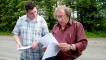 Bruce Durie and resident Chris Irwin examine old property records.