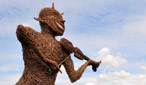 The Cambridge Folk Festival wickerman stands proudly over the festival masses.