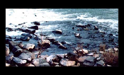 Waves against a pebbly shore