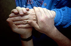 Pensioners hand being held