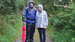 Derek and guide Becky Davies begin their walk in the rain.