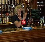 Joan behind the bar