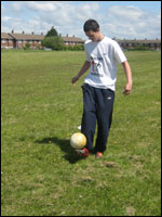 teenager balances ball on foot