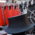 A little man in a harness looks down at a giant top hat.