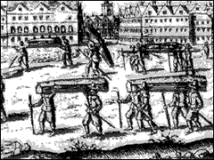 an image of bodies being carried to a mass grave.