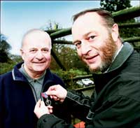 George Hanna receiving the Imperial Service Medal from District Forest Office, John Watson in December 2004 - Picture courtesy of Mourne Observer