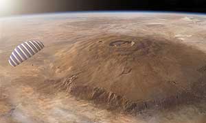 The Ares lander glides over Olympus Mons, the largest volcano in the solar system, as it approaches its landing site on Mars. The paraglider canopy would cover a football field