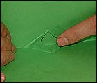 Picture: fold the paper again and open up the cut
