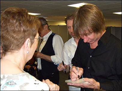 Status Quo band members sign autographs