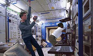 In one of the labs on Pegasus John Pearson (played by  Mark Dexter) films mission scientist Nina Sulman (played by Michelle Joseph) as she carefully unwraps the sample of ice from Europa retrieved by a robotic probe early in the mission