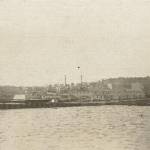 Naden Dockyard, Canada.  Buildings on jetty are where Eric and the crew spent some of their time.  Behind can be seen Funnels of steam of HMCS Prince David and HMCS Prince Robert