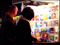 A couple buying music from a stall