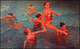 Pic: Syncronised swimmer is held aloft:.