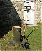 wellies and camera outside farm buildings