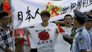 北京反日示威者在日本大使館外舉起呼籲中國民眾抵制日貨的標語(13/9/2012)