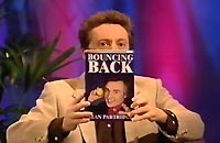 Ray Woollard holds up Bouncing Back