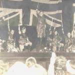 In those extraordinary times the adults at St Georges barracks — mostly evacuees from the bombing themselves — worked hard to give us children ordinary experiences.  We  had a rudimentary school and this Robin Hood scene is from an entertainment organised by Mrs Oakford in 1941. I am second from the left.