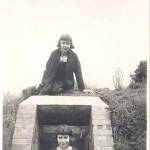Marjorie standing in the doorway, her twin sister sat on the roof of the air raid shelter, aged nearly 13 years old.  This photo was taken during the Summer term of 1941.