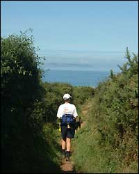 Jo walking - with Lundy in the distance